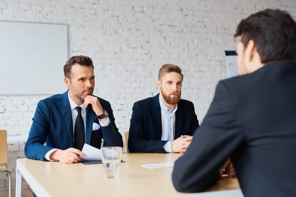 two business man recruit candidate at their office