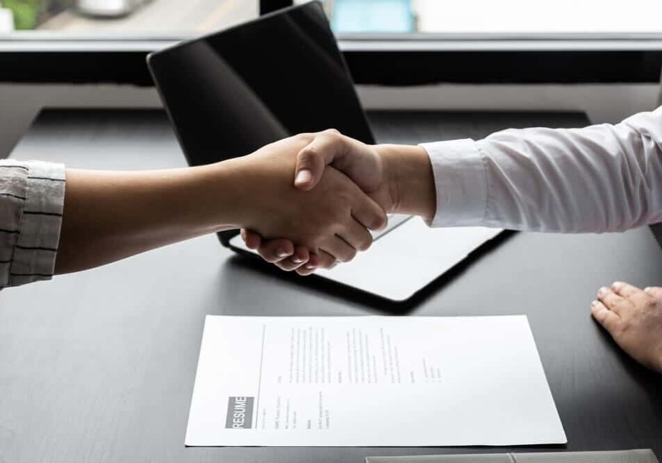 Managers shake hands with applicants after accepting an interview